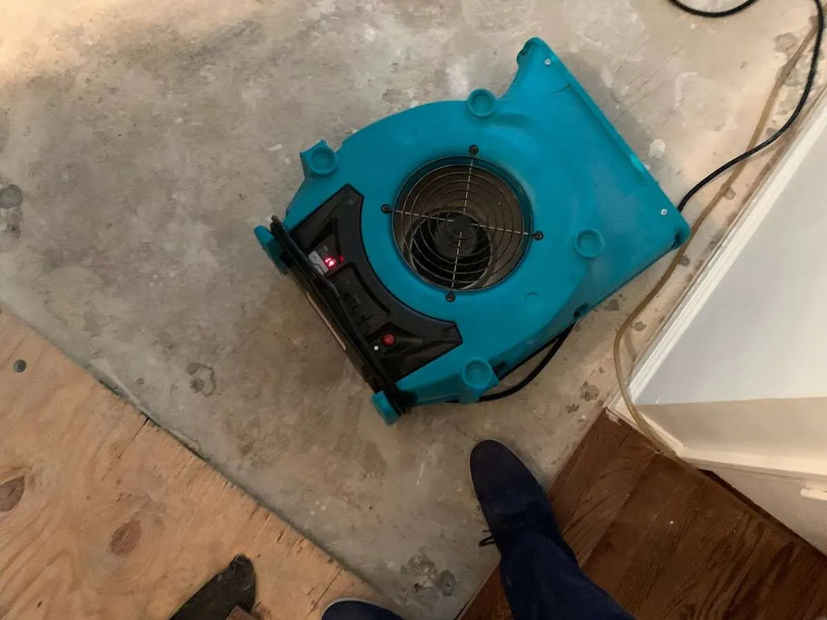Air mover drying subfloor during Leak Detection & Repair in Peterborough